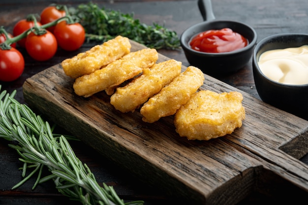 Nuggets breaded on dark wooden table.