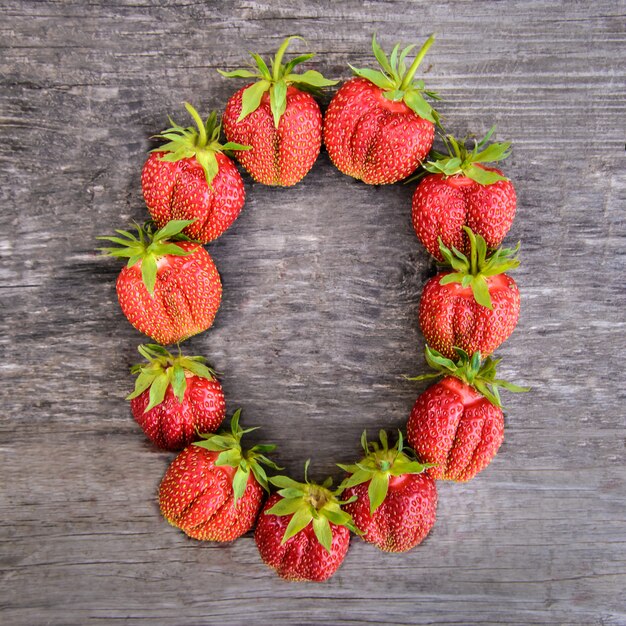 Number 0 of strawberries on wooden background