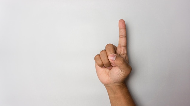 number 1 hand sign isolated on white pointing the finger man hand number one gesture