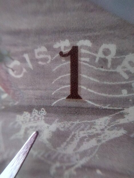 A number 1 is on a cloth with a pair of scissors.