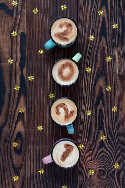 金の星が付いている茶色の木製のテーブルの上の4つのコーヒーカップの番号2021