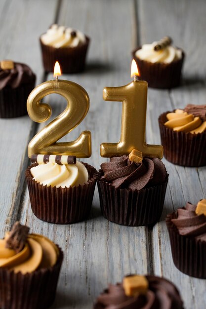 Number 21 celebration birthday cupcakes on a wooden background