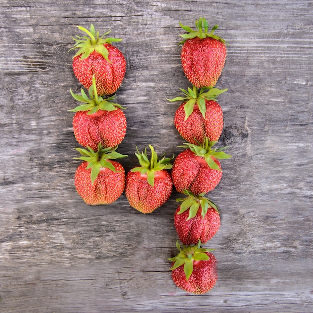 Number 4 of strawberries on wooden background