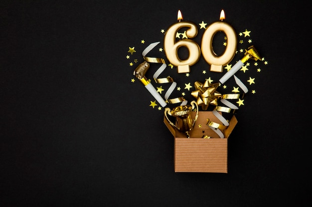 Number 60 gold celebration candle and gift box background