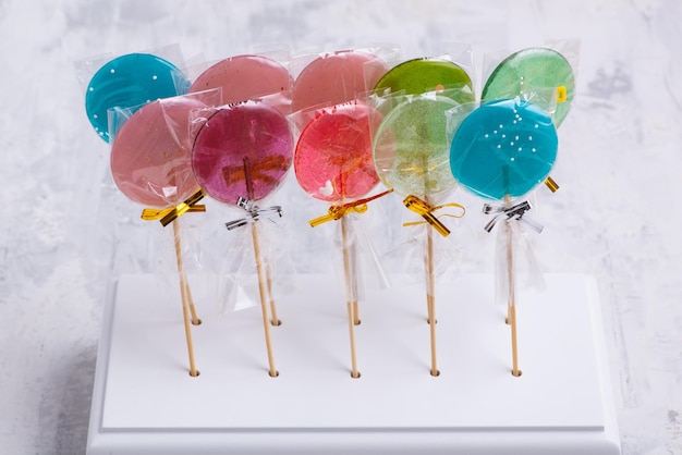 Photo number of colorful lollipops on a white surface