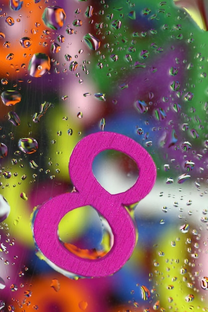 Number eight on abstract colorful drops background