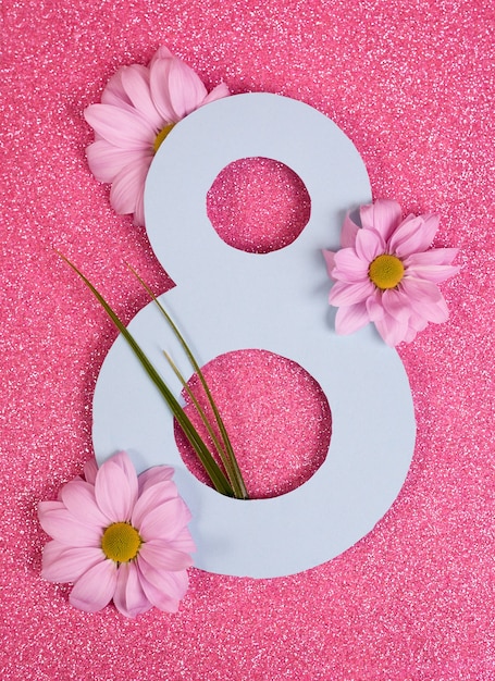 Number eight cutted in paper against pink glitter background.\
good for 8 march, international woman day banner.