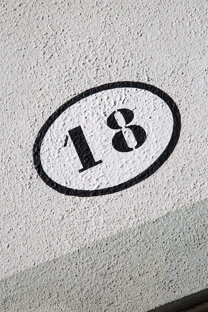 Number Eighteen on Stone Wall on Diagonal Tilt