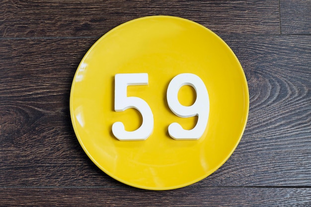 The number fiftynine on the yellow plate