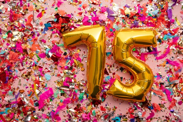 Number  gold birthday celebration balloon on a confetti glitter background