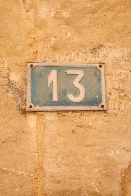 Number Thirteen on Stone Wall