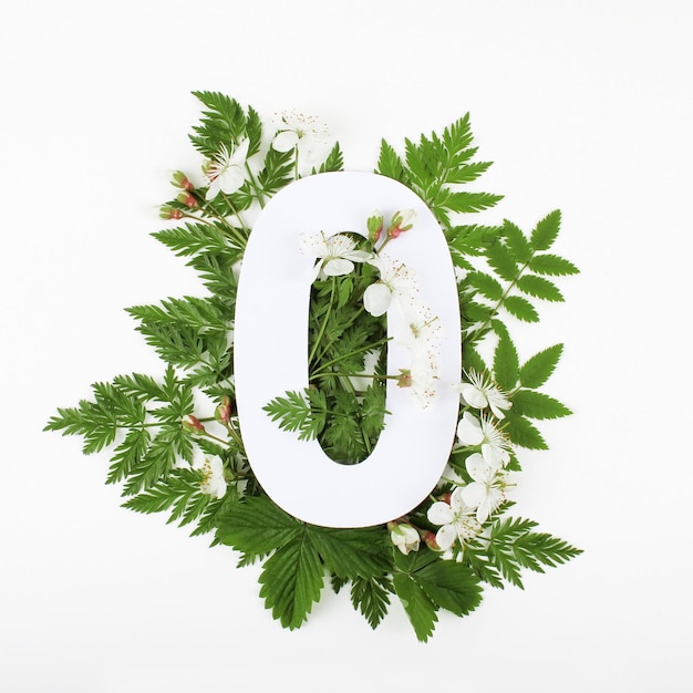 Photo number zero with cherry blossoms and green leaves minimal summer concept flat lay