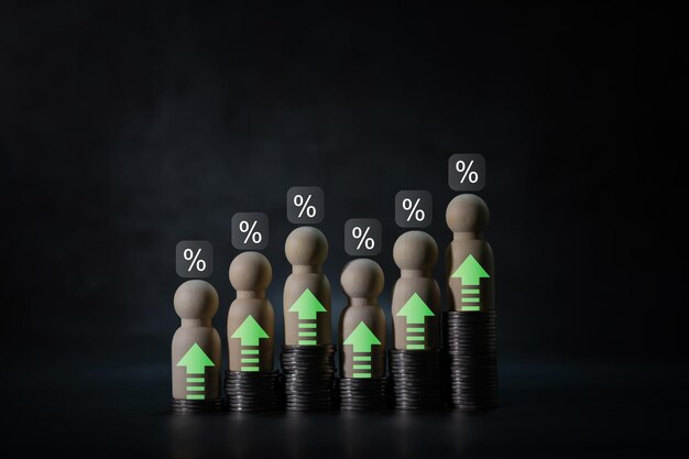 Photo numerous coins are stacked in a graph with wooden figurines up and down arrow of businessman