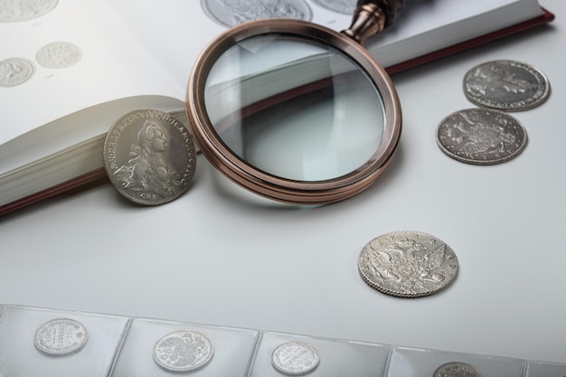 Numismatics. Old collectible coins on a table. light background.