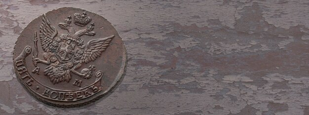 Numismatics. Old collectible coins on a wooden table. Top view. Copy space of your text.