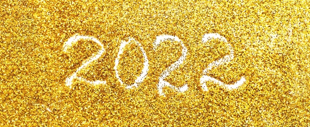 nummer 2022 geschreven op gouden confetti kerst of nieuwjaar achtergrond