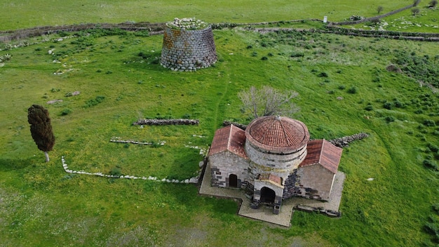 Photo nuraghe santa sabina in silanus in central sardinia with the church of santa serbana next to it