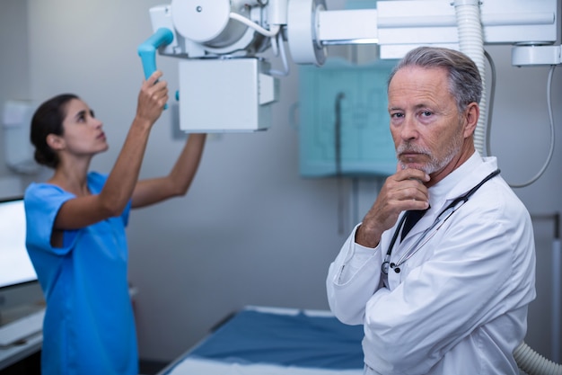 Nurse adjusting x-ray machine