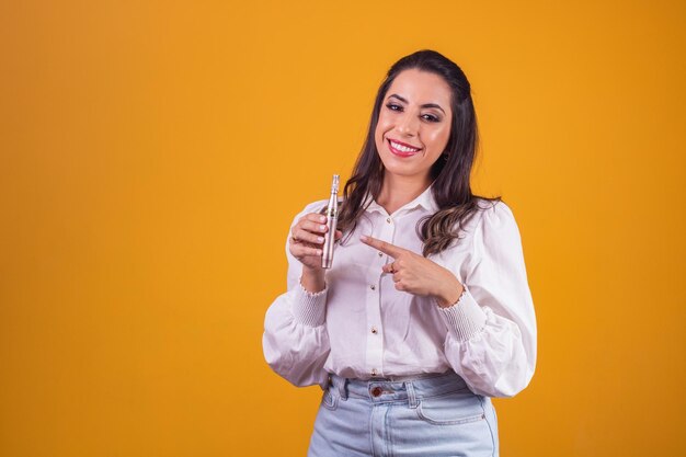 Nurse and beautician holding a dermapen for lip hydration on yellow background.