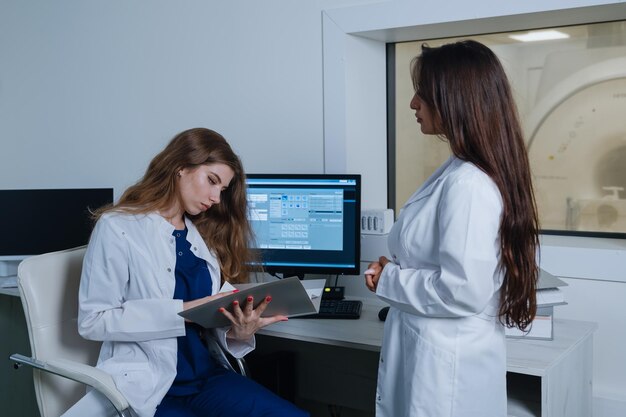 The nurse brought the woman doctor the patient's card to the radiologist's office