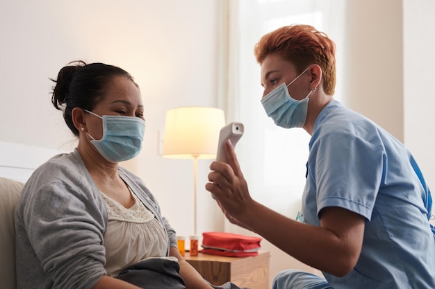 Nurse caring about senior woman