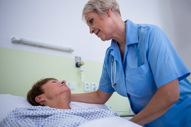 Nurse checking patient temperature