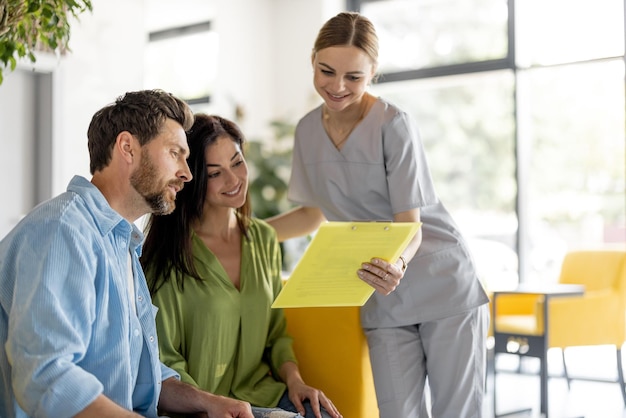 Nurse communicates with patients in waiting room of a clinic