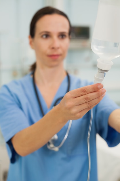 Nurse connecting an intravenous drip