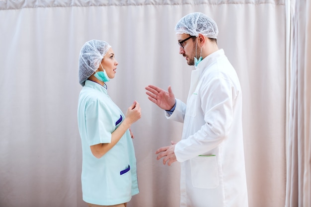 Nurse and doctor discussing about health of patient.