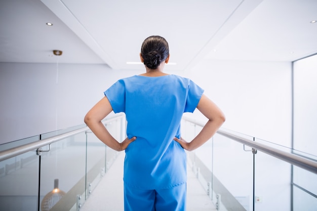 Nurse and doctor discussing over clipboard