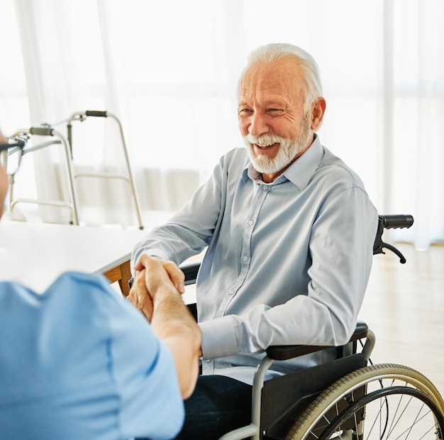 Nurse doctor senior care caregiver help assistance retirement home hospital nursing man handshake