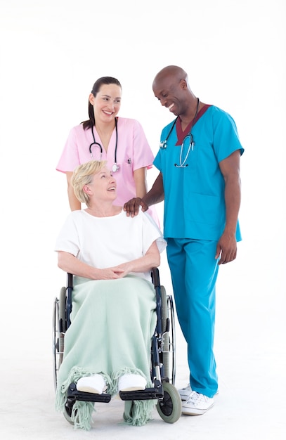 NUrse and doctor with a patient in a wheel chair