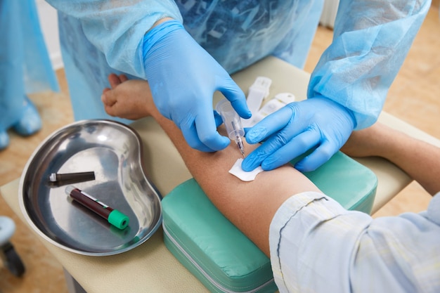 Nurse doing blood test from vein. Covid testing concept