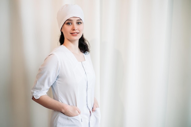 Nurse dressed in medical gown looking at the camera