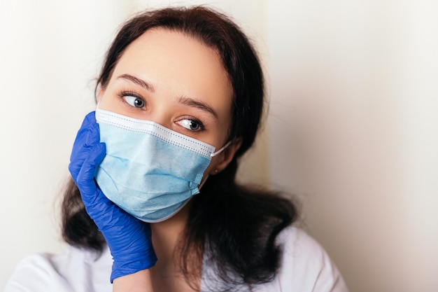 Nurse dressed in medical gown and wear face mask