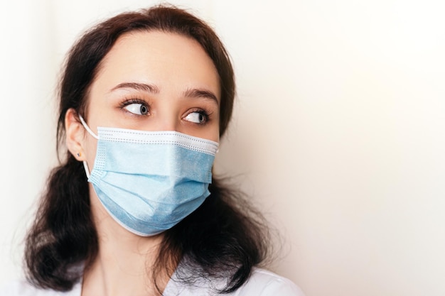 Nurse dressed in medical gown and wear face mask