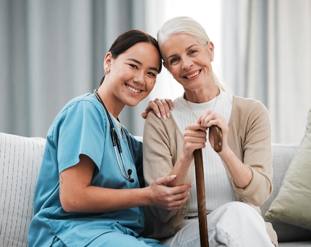 Nurse elderly woman and sofa for portrait walking stick and smile together with happiness chat and care Senior patient asian doctor and couch with helping hand happy and connection for support