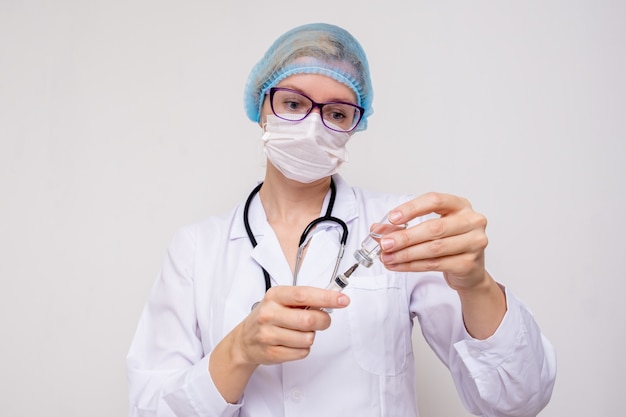 A nurse filling the syringe with medicine or vaccine, immunisation concept