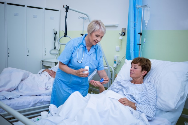 nurse giving medication to patient