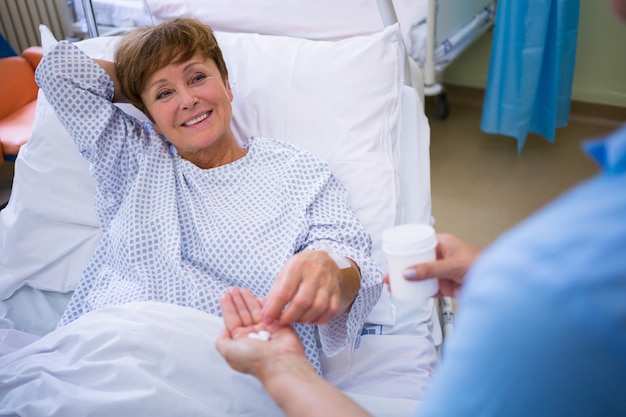 Photo nurse giving medication to patient