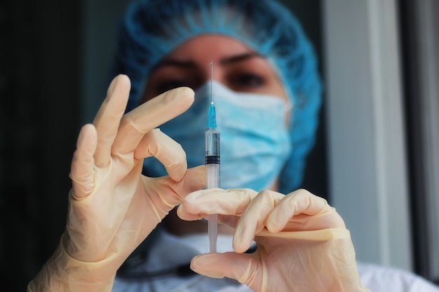 nurse hands holding syringe and ampoule