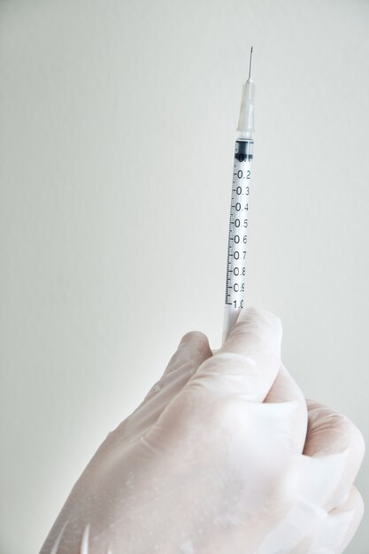 Nurse hands wearing gloves ready to vaccinate