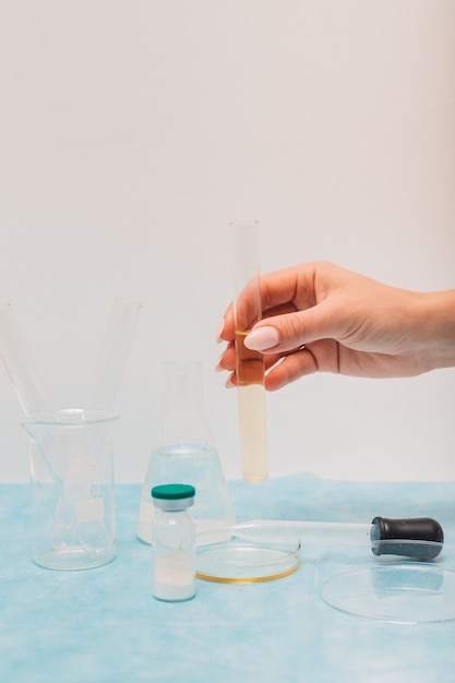 Nurse hands with test tubes and medical solutions