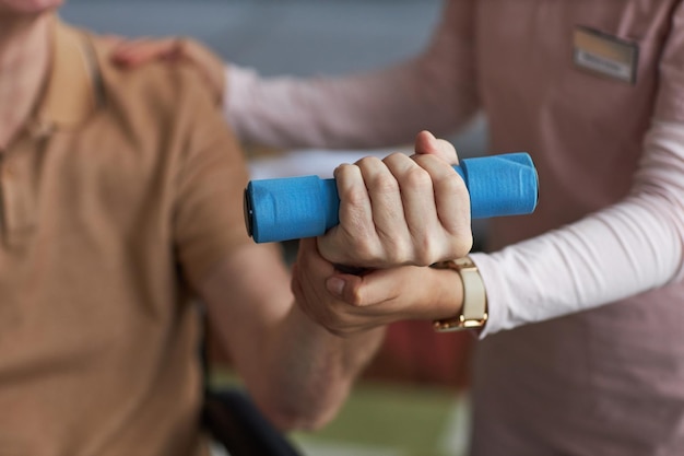 Nurse helping senior man with exercise