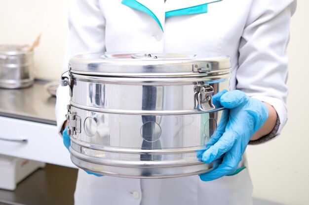 A nurse holding a bix with sterile instruments