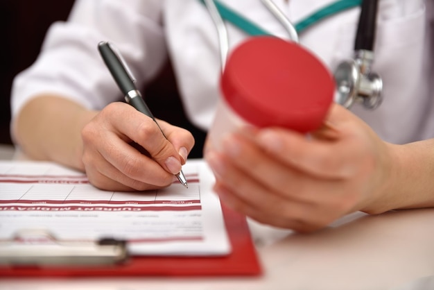 Nurse holding container with tablet