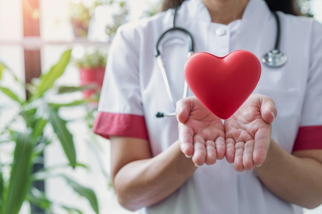 Photo nurse holding heart on world health day generative ai