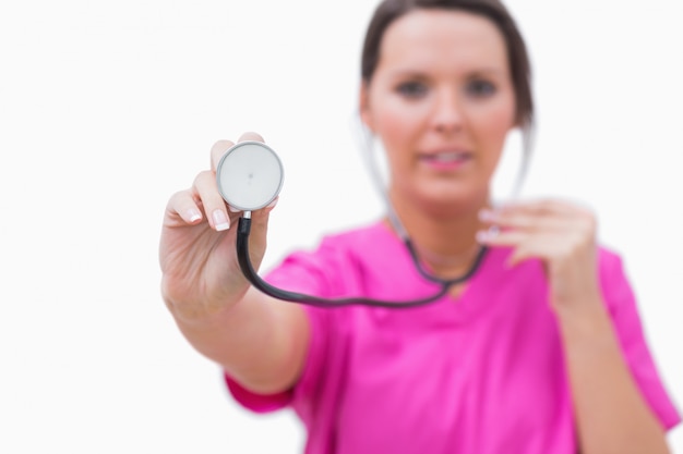 Nurse holding out stethoscope