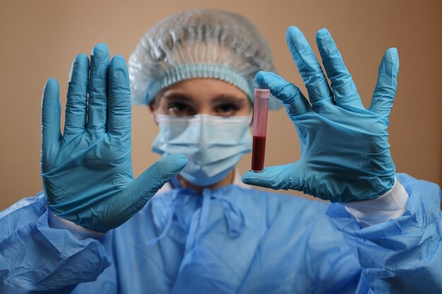 A nurse holds a test tube with a coronavirus positive blood sample 2019 nCoV pandemic MERS