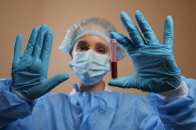 A nurse holds a test tube with a coronavirus positive blood sample 2019 nCoV pandemic MERS